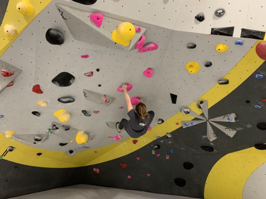 Senior+Emma+Bennett+climbs+her+way+up+a+wall+at+High+Point+Climbing+and+Fitness.