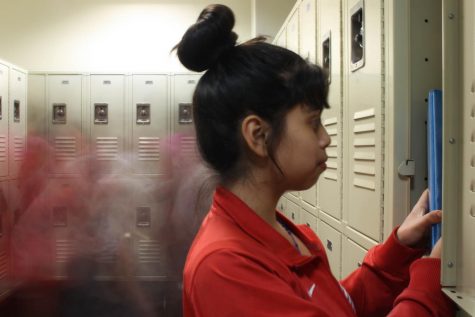 Eighth grader Jennifer Lopez poses looking through her locker. In the whirl of 
everyday school life, students can feel overlooked.