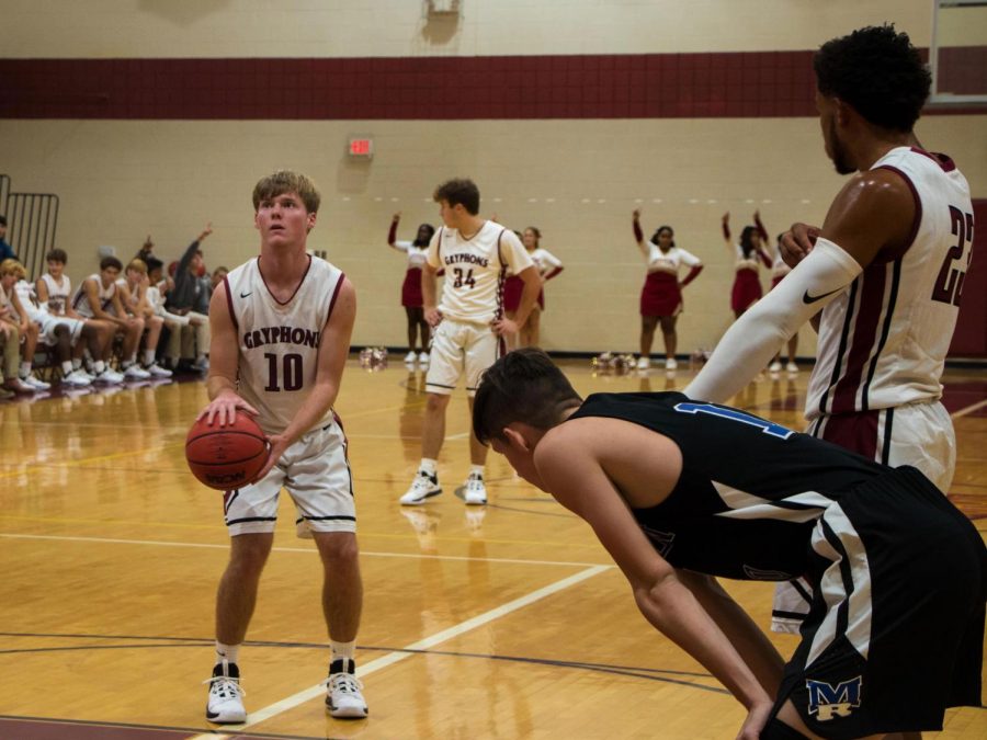 Benjamin Lambert lines up to take a free throw shot.  Lambert has played Varsity Basketball for three years.