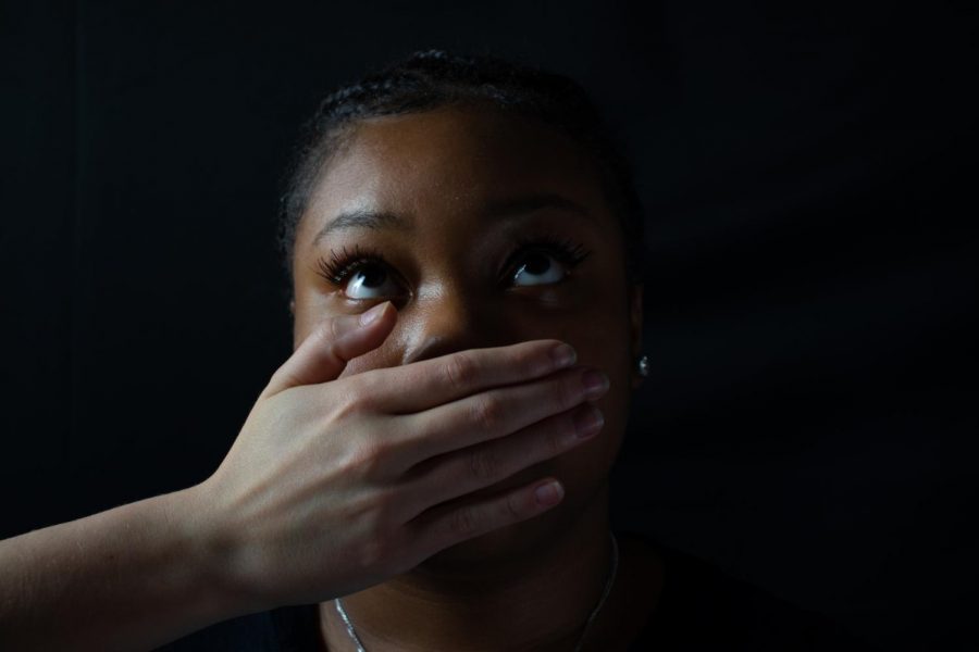 Junior Dariya Jones has a hand over her mouth, trying to cover up her words. In the article, Jones describes what she has the right to say.