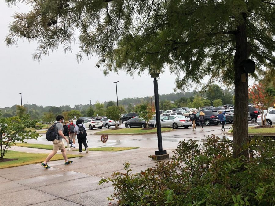 Seniors walk to their cars after the announcement of the suspension of in-person learning for the upper school. Dismissal occurred shortly after lunch.  
