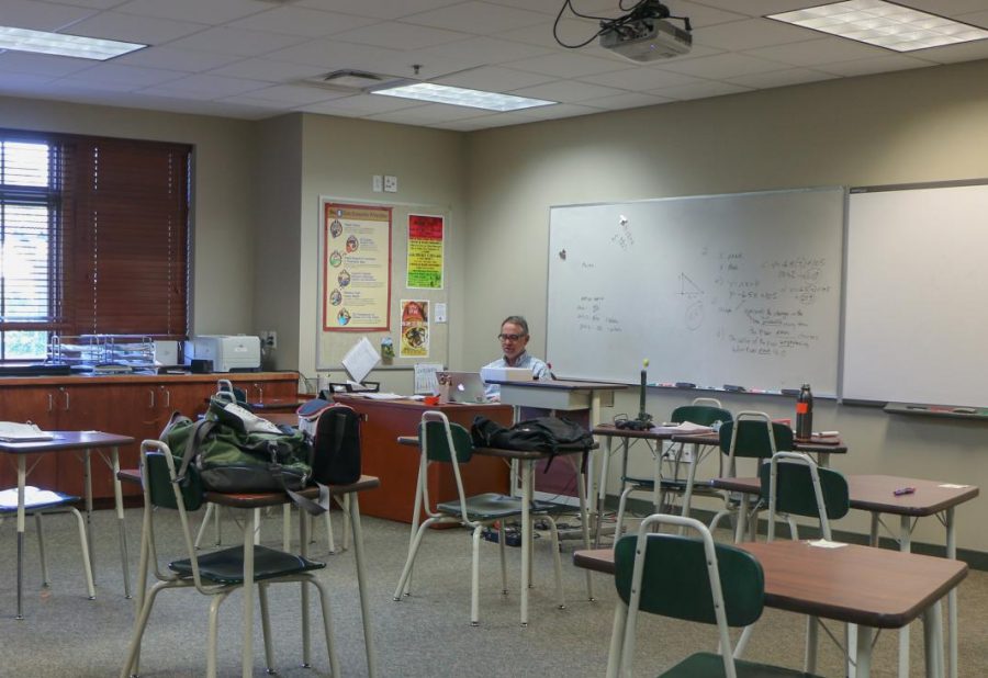 Bruce Timmons sits in his empty classroom while students are remote due to COVID-19. Canvas played an essential role in allowing students to learn from home.