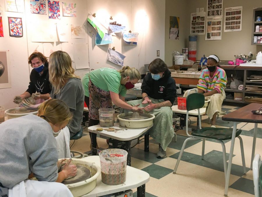 Mrs.+Webb+helps+junior+Joe+Walters+throw+on+the+wheel.+Mrs.+Webb+has+faced+many+challenges+this+year+with+Pottery+online.+This+class+has+become+available+to+only+in-person+students+now.