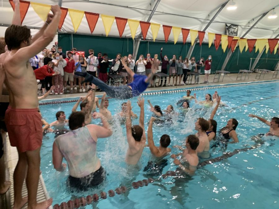 Choir teacher Mr. Nathan Dumser swan dives into the middle of a jubilant senior-filled pool.
