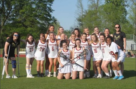 The Varsity Womens Lacrosse team and their two co-coaches, Ms. Emily Metz and Ms. Claire Zagrodzky, pose for a picture on Senior Night for Womens Lacrosse.