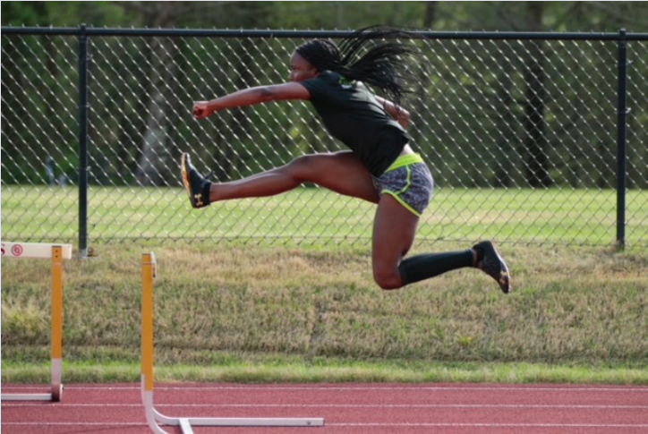Rising track star Freshman, Kimbriel WInfield, runs hurdles in practice in preparation for her next meet.