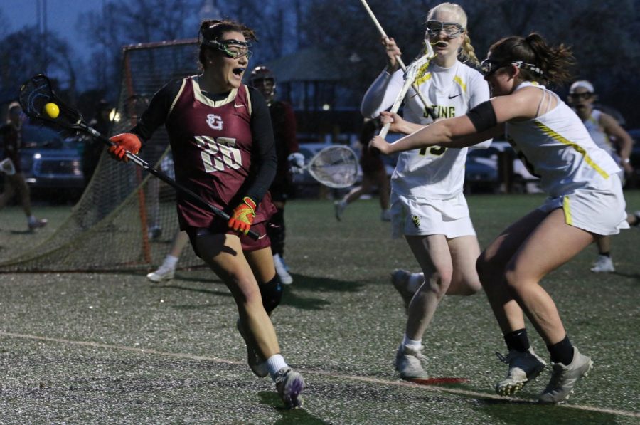 Reese Dlabach ‘23 cradles the ball while looking for an open teammate.