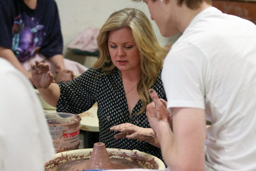 Mrs. Webb throws clay with her upper school pottery class.