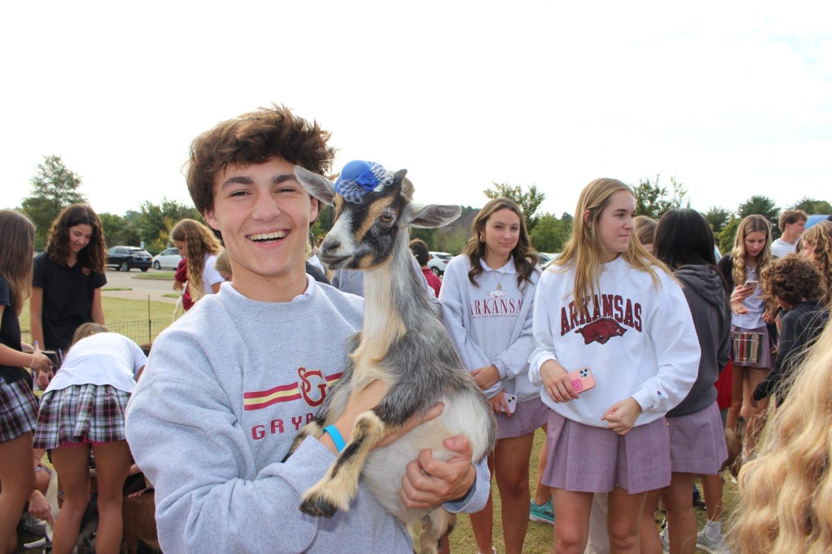 Sophomore Evan Asbell poses with one of the 901 Goats that were brought to St. George’s on Monday. 
