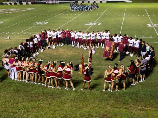 Members of the St. George's community join the football and cheer teams in a post-game Wagon Wheel celebration on Thurs., Aug. 21, at Collinwood High School.